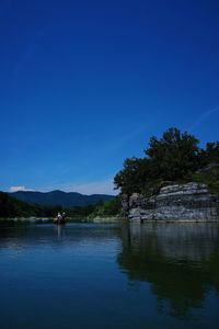 Scenic view of lake against blue sky