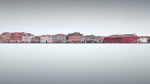 Houses in town against clear sky