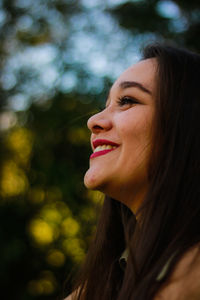 Close-up smiling young woman looking away