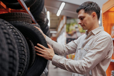 Man choosing tire at store