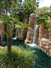 Scenic view of waterfall against sky