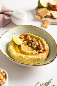 Classic hummus with spices and lime in a bowl