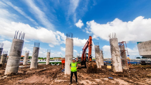 Man standing on construction site against sky