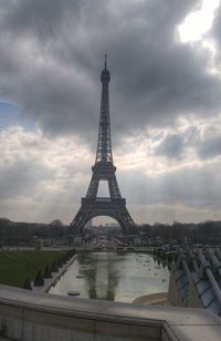 Eiffel tower against cloudy sky