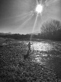Man standing on field against sky