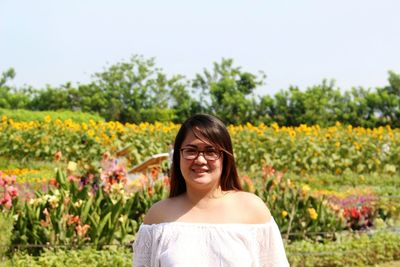 Portrait of smiling young woman in field