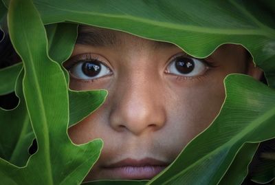 Close-up portrait of girl amidst leaves