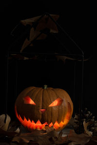 Close-up of illuminated lanterns against black background