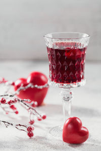 Red cocktail, vodka or liqueur and heart shape decorations