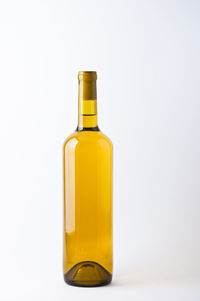 Close-up of yellow bottle against white background