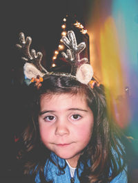 Portrait of cute girl wearing headband during christmas at home