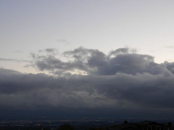 View of cityscape against cloudy sky