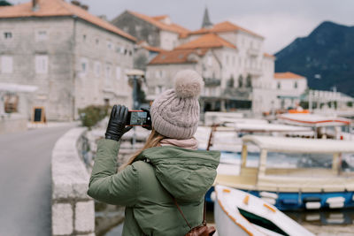 Side view of man photographing with camera