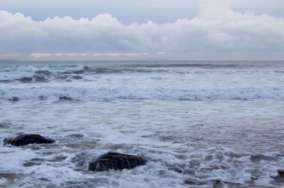 Scenic view of sea against cloudy sky