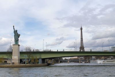 View of bridge over river against cloudy sky