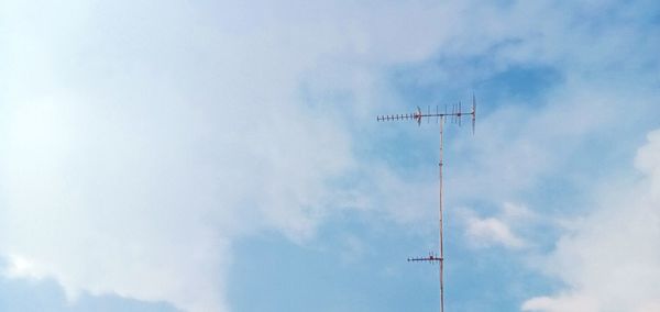 Low angle view of communications tower against sky