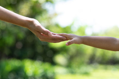 Midsection of couple holding hands