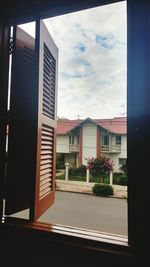 View of apartment building against cloudy sky