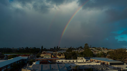 Rainbow over buildings in town