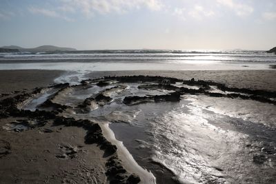 High angle view of muddy seascape against cloudy sky