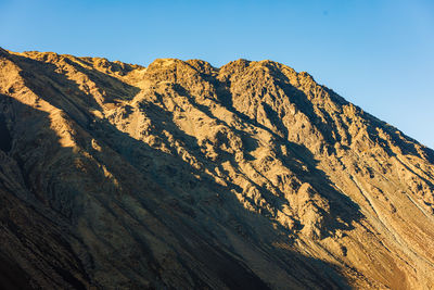 Scenic view of rocky mountains against clear sky