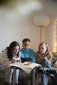 Children playing video games at home