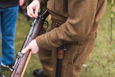 Soldier holding gun outdoors