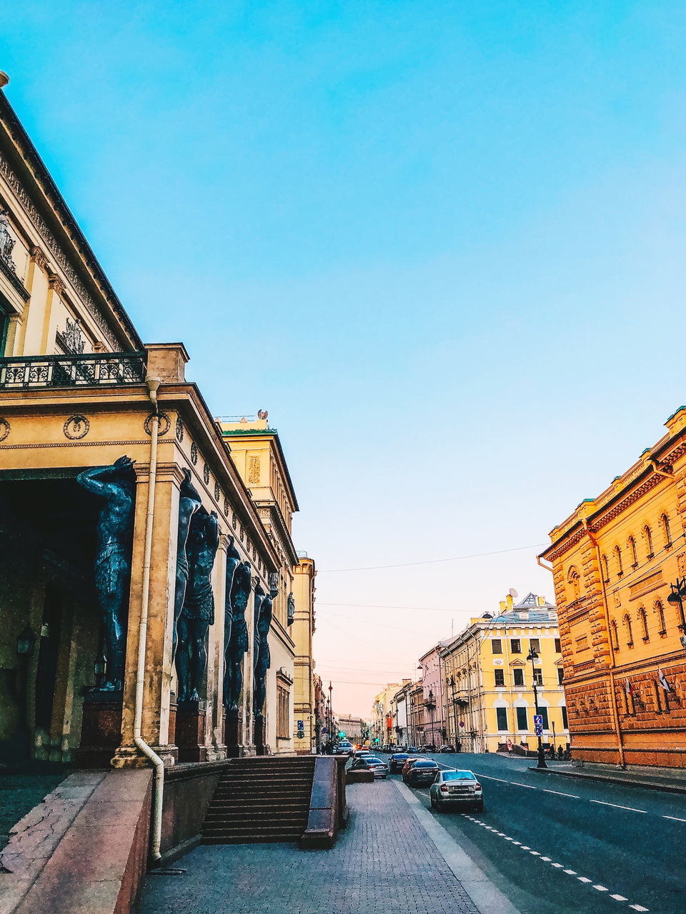 STREET AMIDST OLD BUILDINGS AGAINST SKY