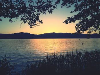 Scenic view of lake at sunset