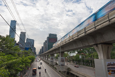 Cars on road amidst buildings against sky