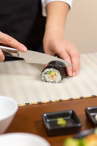 Midsection of man holding sushi
