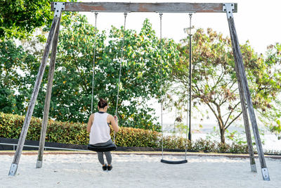 Rear view of woman standing by plants