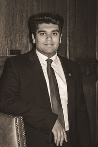 Portrait of young businessman standing at home