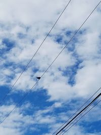 Low angle view of electricity pylon against sky