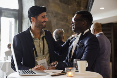 Happy businessmen looking at each other during seminar