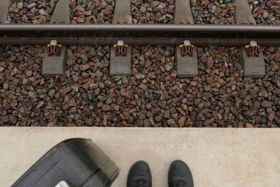 High angle view of shoes and luggage on railroad station platform