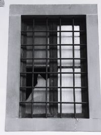 Low angle view of building seen through glass window