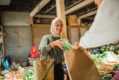 Portrait of young woman standing in store