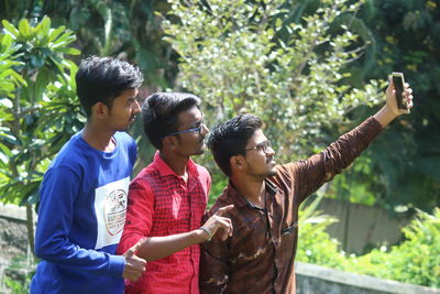 Friends standing on mobile phone