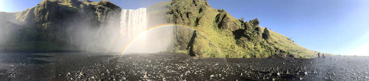 Low angle view of skogafoss falls sunny day in iceland.