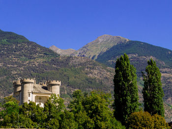 Scenic view of mountains against clear blue sky