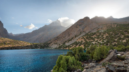 Scenic view of lake and mountains against sky