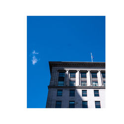 Low angle view of building against clear blue sky