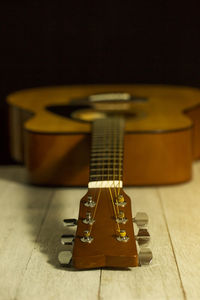 Close-up of acoustic guitar on table