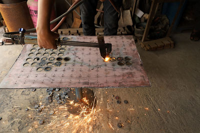 Low section of people working on wood