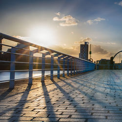 View of bridge in city at sunset