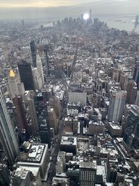 High angle view of modern buildings in city against sky