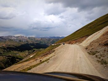 Road amidst landscape seen through car windshield