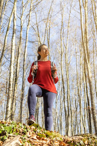 Portrait of woman standing on tree