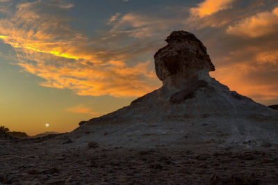 Rock formations against sky during sunset